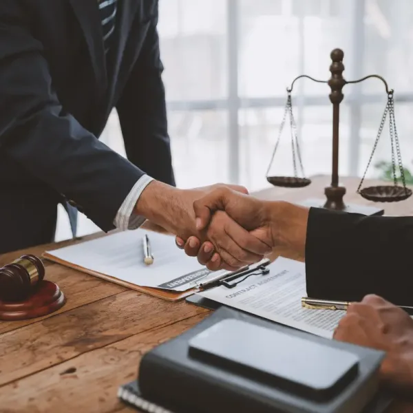 lawyers-join-hands-with-business-people-to-sign-a-2025-02-19-20-51-23-utc.webp